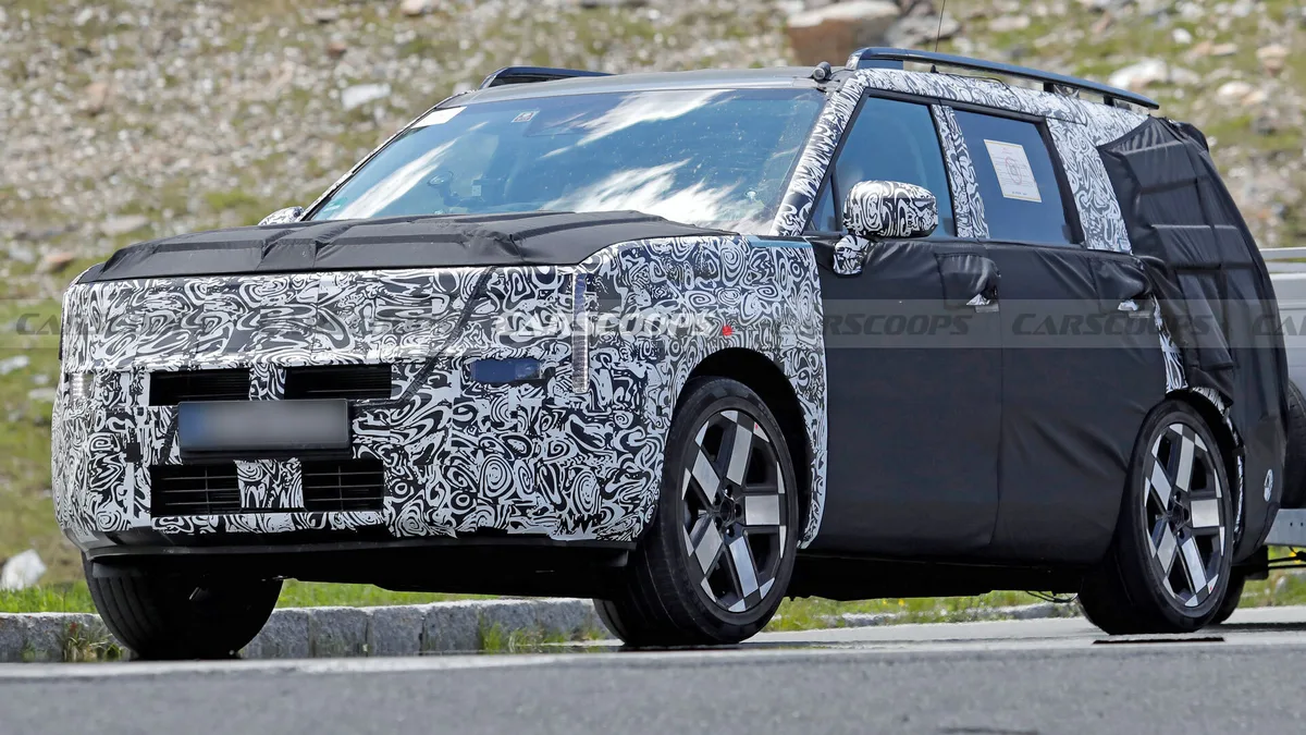 Hyundai Santa Fe facelift prototype spy shot showing camouflaged SUV on road