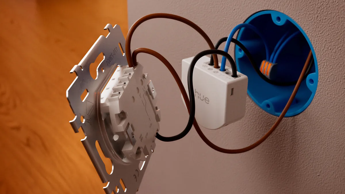 Philips Hue wired wall module smart lighting hardware installed behind a wall switch