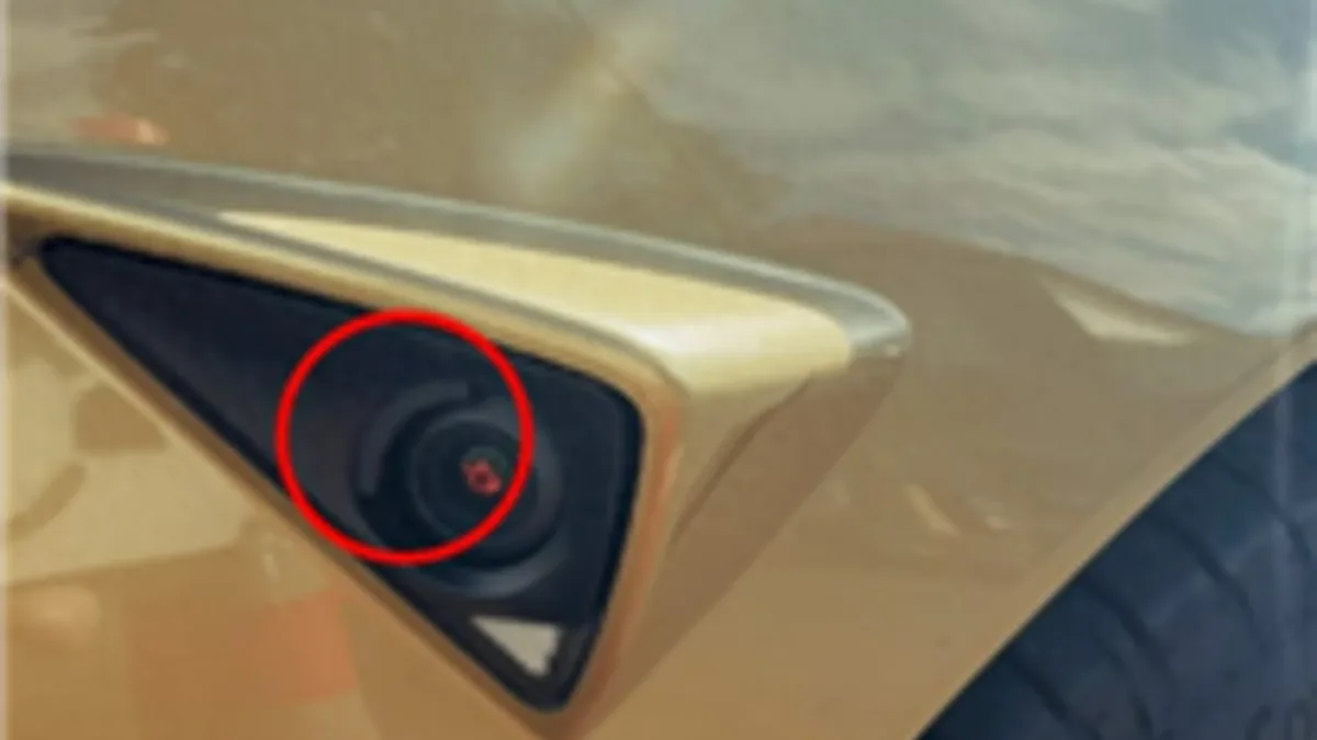 Tesla Cybercab side camera washer hardware visible on a prototype vehicle