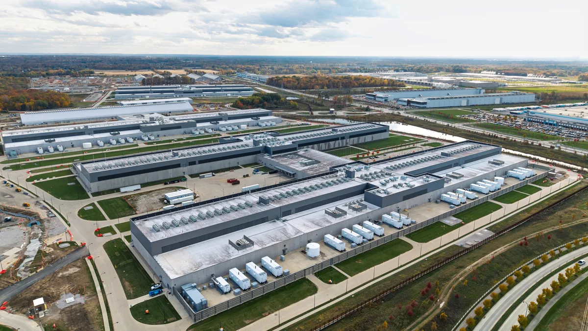 AI data center beside emergency power grid equipment during heatwave
