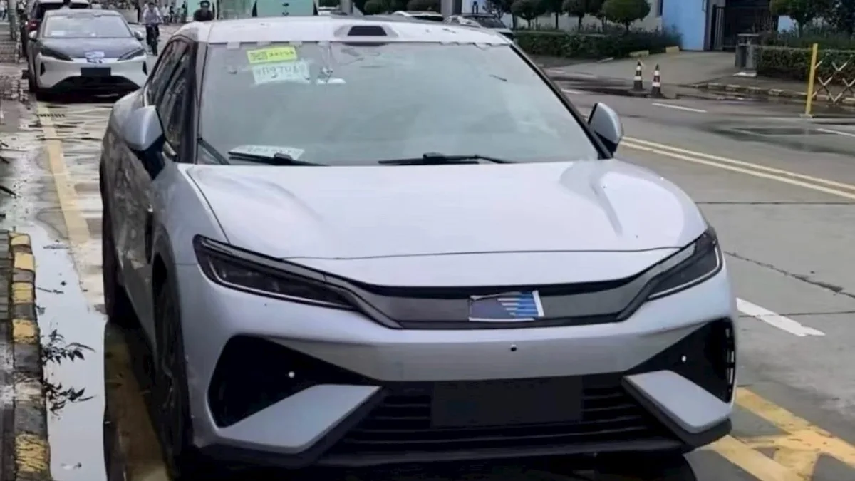 Camouflaged BYD electric GT sports car on public road