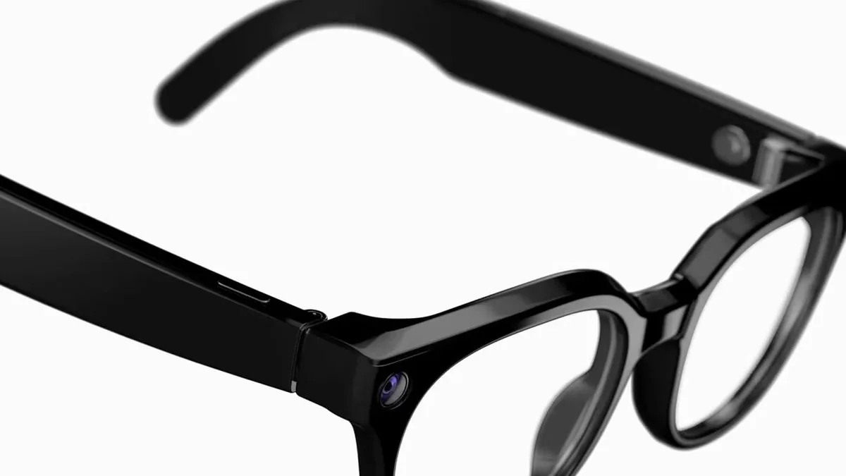 Smart glasses on a table with a phone and wearable charging case