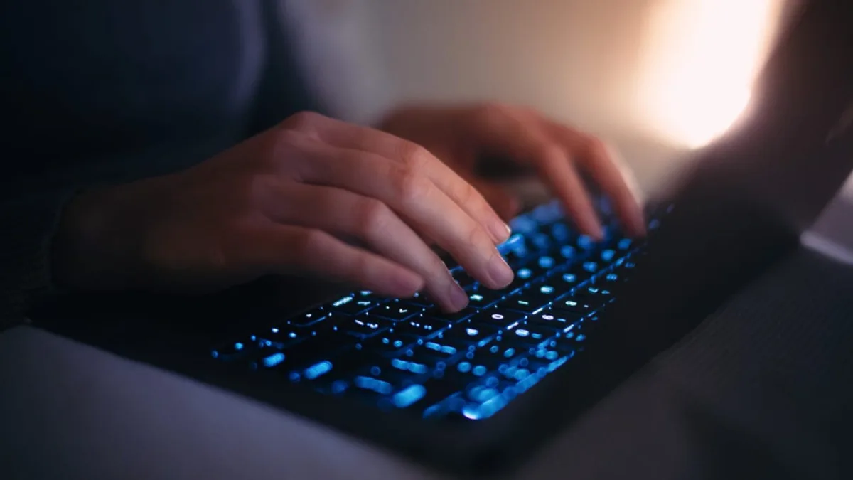Cybersecurity analyst watching AI-driven ransomware activity on monitors